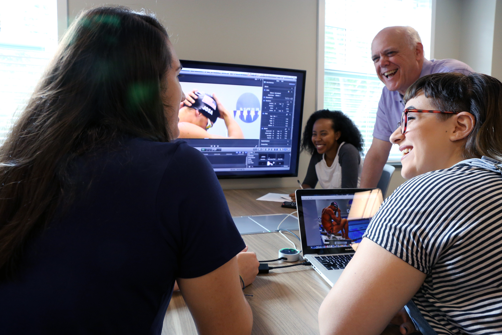 Students Ella Fox, Hiwot Hailu, and Abby Laine Faber prepare for Rio de Janeiro with Bob Page, advisor to student media at Queens University of Charlotte.