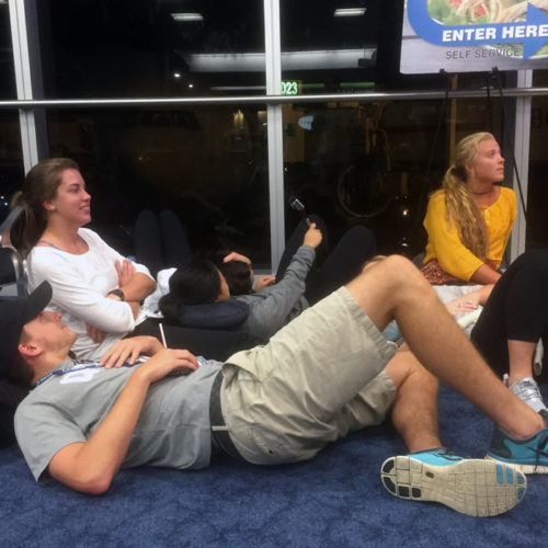 Queens students Austin Huddy, Abby Tolar, Becca Chen (selfie stick), and Kelsey McCormick watch opening ceremonies of the Rio 2016 Olympic Games on a layover at Miami airport, Aug. 5, 2016.